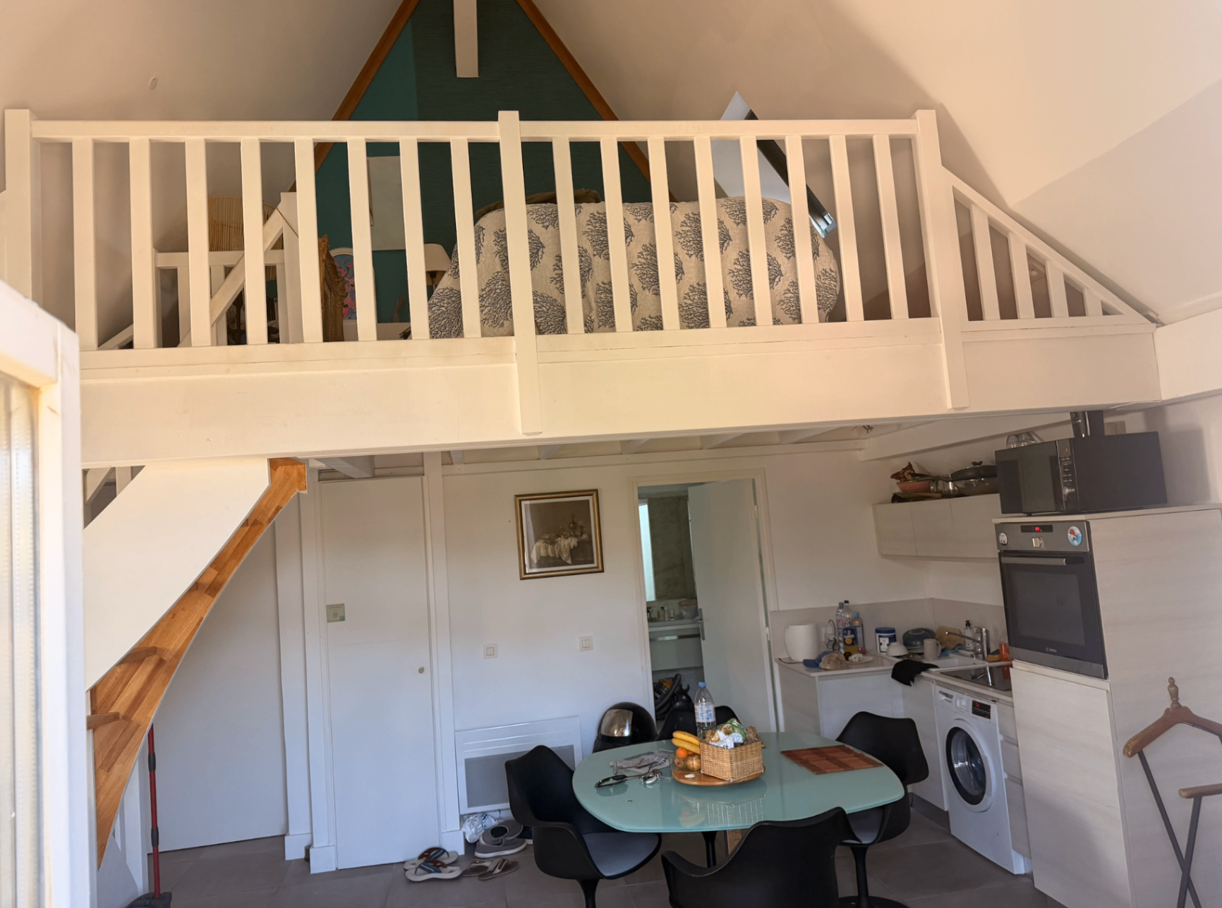 Open living, kitchen and mezzanine loft under vaulted ceiling