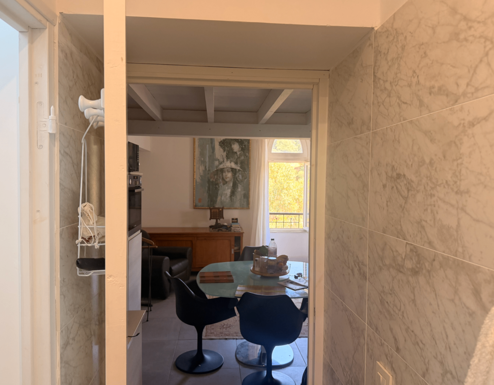 Dining area with Tulip chairs and glass table