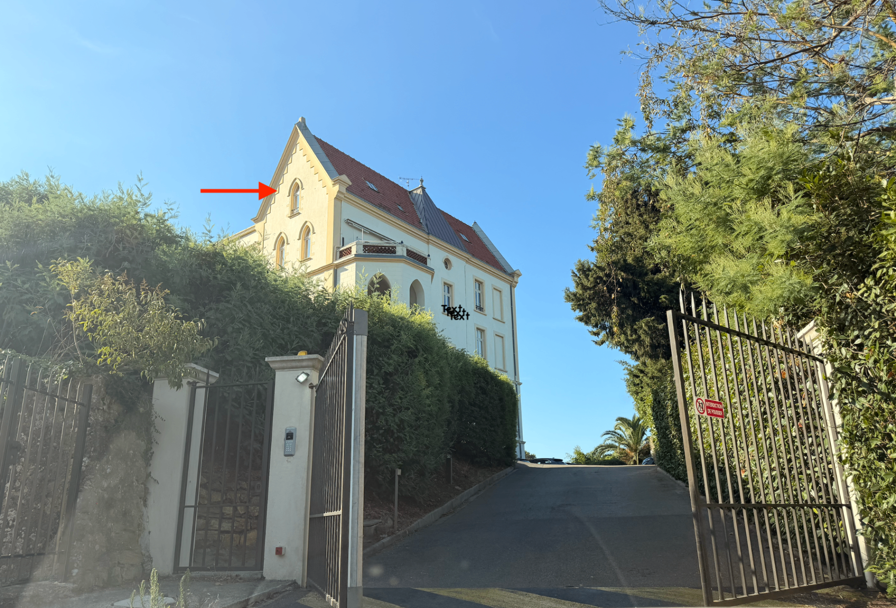 Kensington residence and gated drive with the unit window marked above the gable