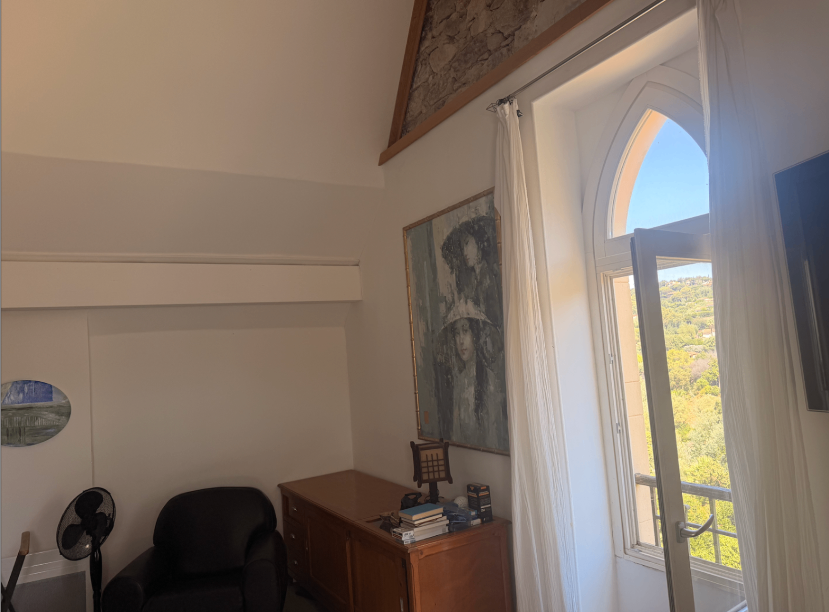 Bedroom nook with arched window looking out to the hills