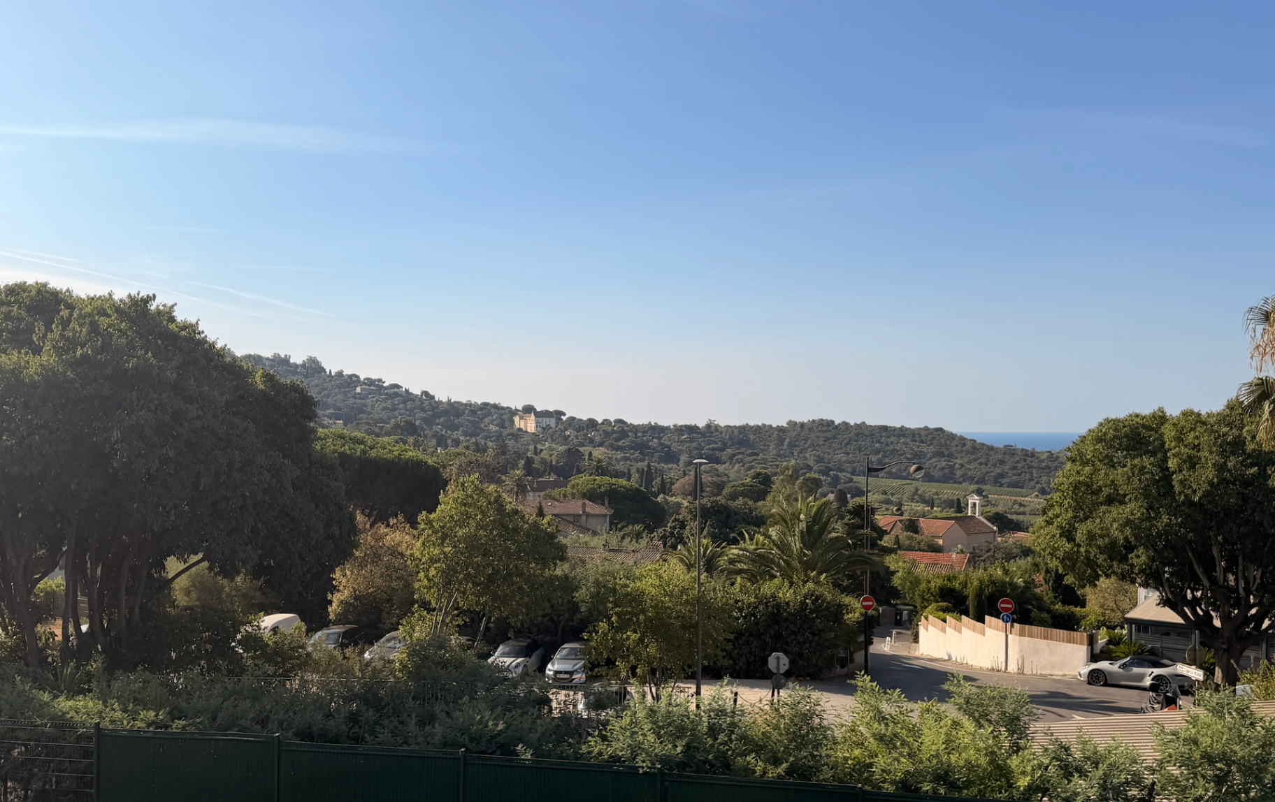 Valley view over vineyards with a glimpse of the sea beyond