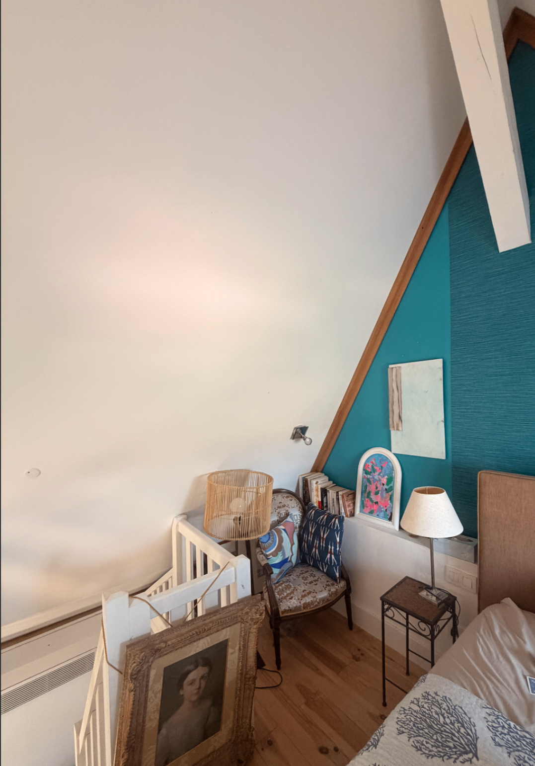 Reading corner with teal wallpaper and vintage armchair