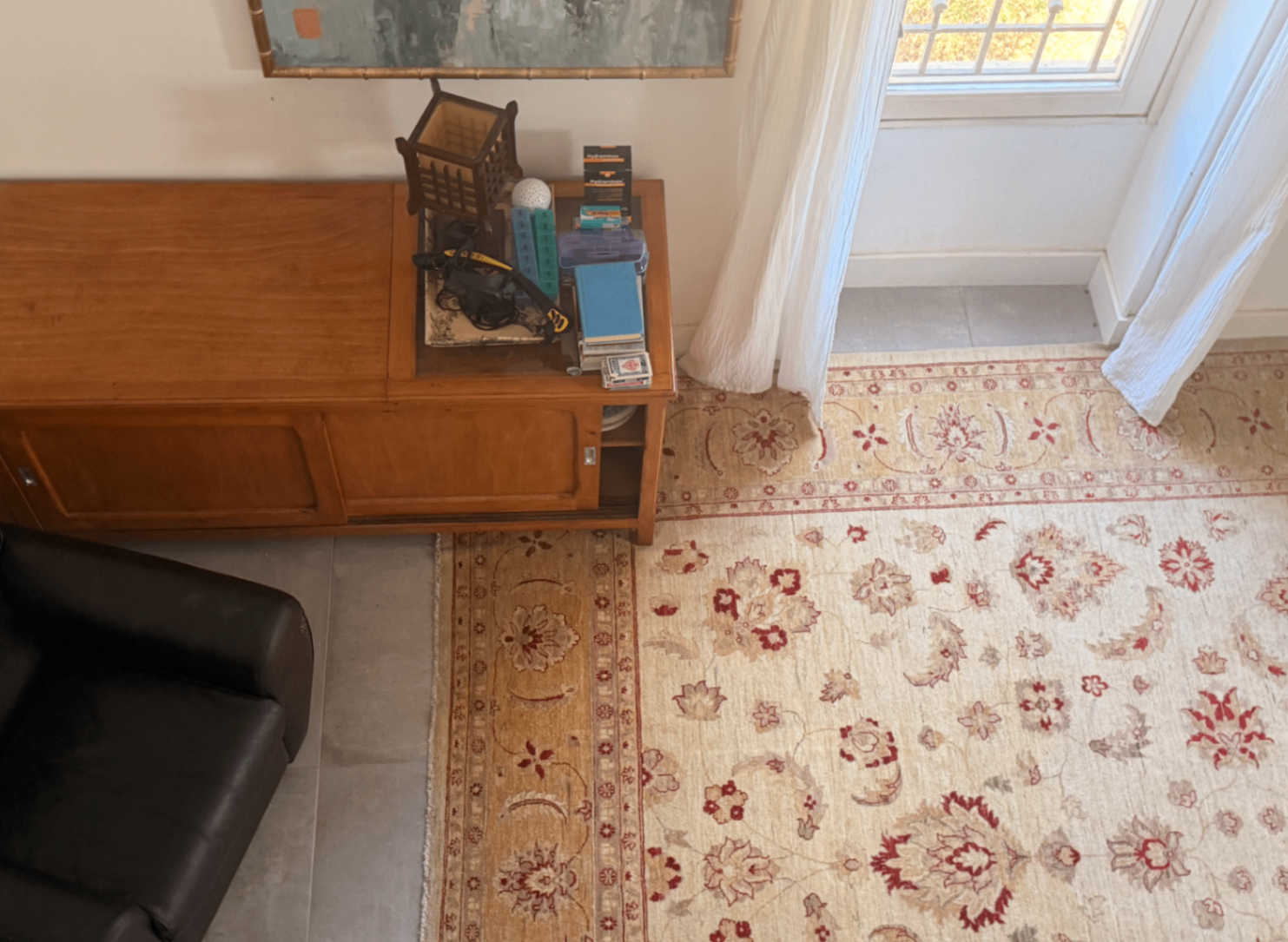Living area with Persian rug and vintage credenza