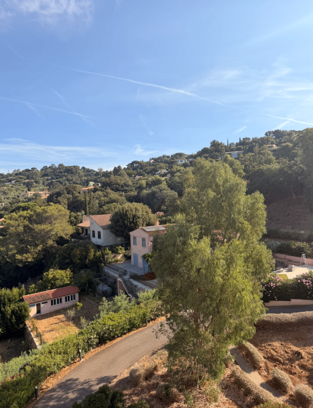 View across pastel villas and winding roads from the residence