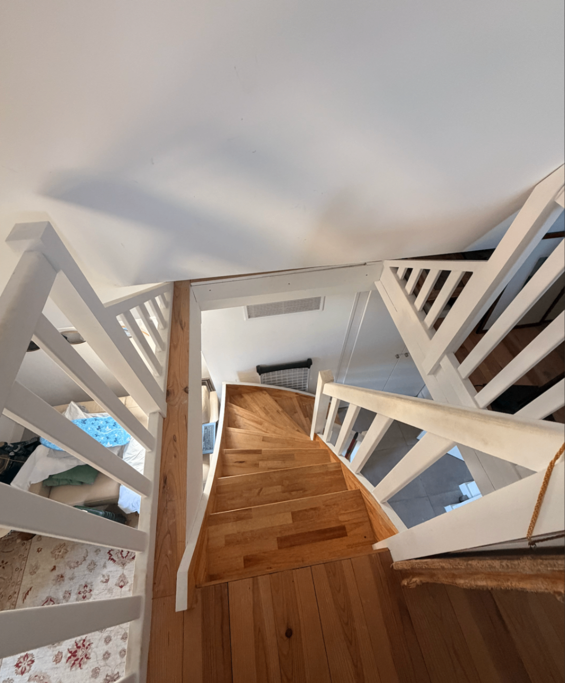 White-painted spiral staircase in warm oak
